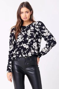 black and white floral top with slightly puffed  long sleeves
