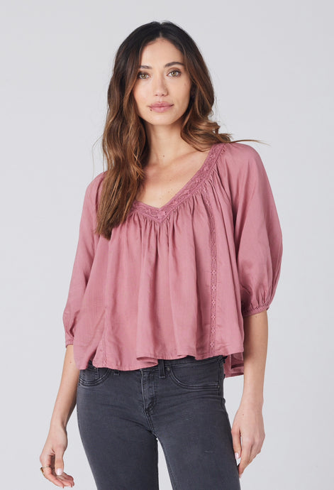 flowy rose top with crochet detail at neckline. v-neck front and back