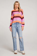 striped loose knit sweater in pink, coral, and burgundy stripes