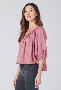 flowy rose top with crochet detail at neckline. v-neck front and back